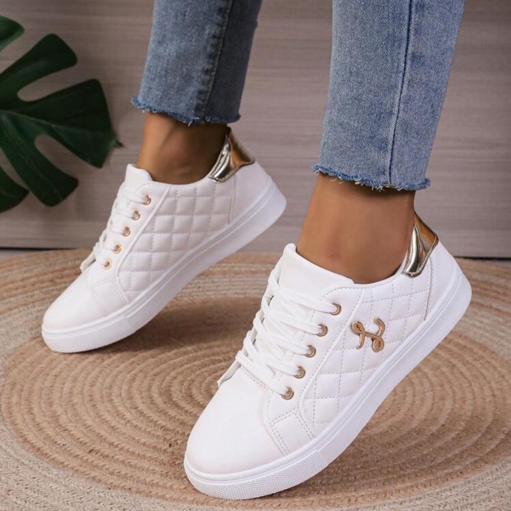 Lace up women’s white sports shoes. Casual white sneakers